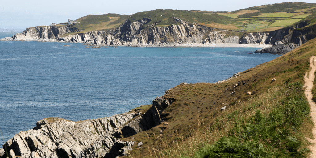 North Devon coastline with rugged cliffs, coastal path and sweeping sea views, showcasing the dramatic landscape of the South West of England on a clear day