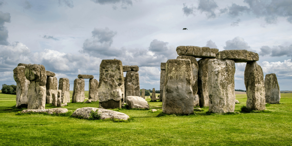 Stonehenge in Wiltshire, England, with ancient standing stones set against open countryside and dramatic skies, showcasing one of the UK’s most iconic prehistoric landmarks.
