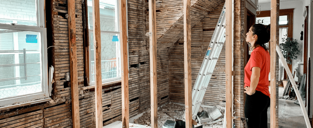 Woman stood amongst a home renovation site