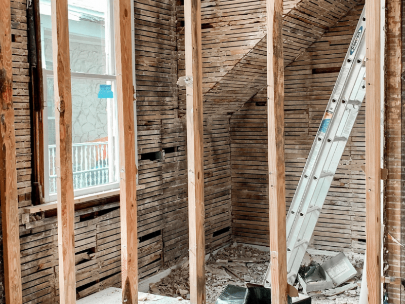 Woman stood amongst a home renovation site