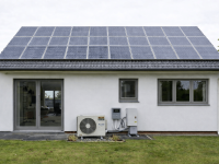 a house with both solar panels and heat pumps