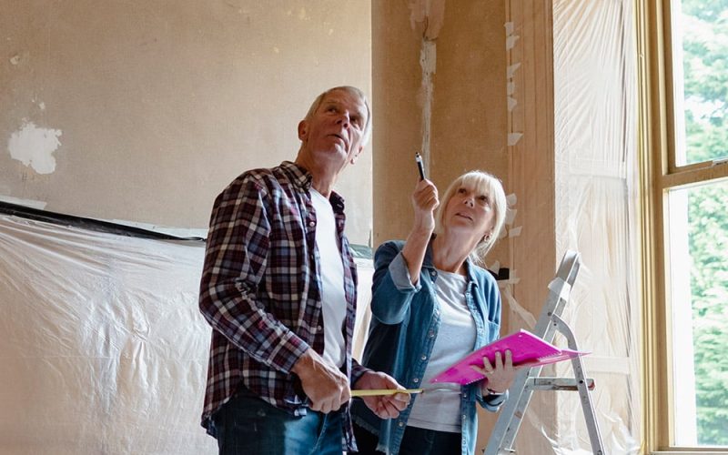 a couple talking and making decisions in a room being renovated