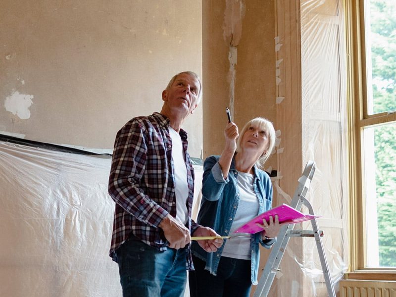 a couple talking and making decisions in a room being renovated
