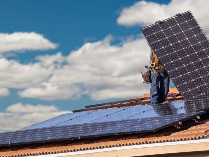 installers on a roof fitting solar panels