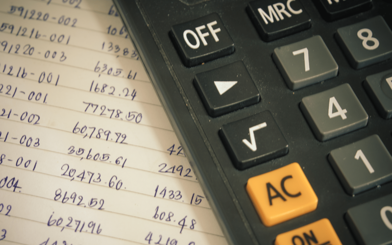 a page with lots of numbers and a calculator nearby, to figure out the apr on a loan