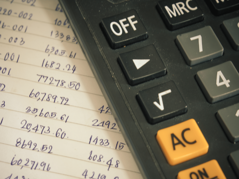 a page with lots of numbers and a calculator nearby, to figure out the apr on a loan