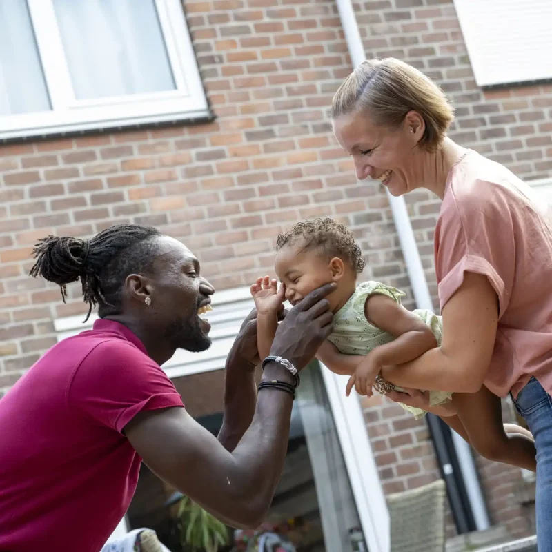 smiling-family-playing-with-a-toddler-outside-thei-2024-09-24-01-37-10-utc